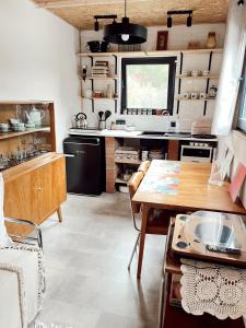 a kitchen with a wooden table and a dining room at Tiny Home Kontík in Luka nad Jihlavou