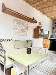 a living room with a green table and chairs at Tiny Home Kontík in Luka nad Jihlavou