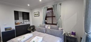 a small bedroom with a bed and a window at Room on the River in Cruden Bay