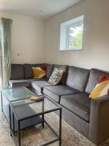 a living room with a couch and a glass table at Exquisite Long-Term Living in Cardiff's Heart in Cardiff