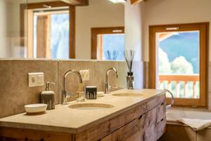 a bathroom counter with two sinks and a mirror at Chalet le 4 - 13 personnes in Le Grand-Bornand