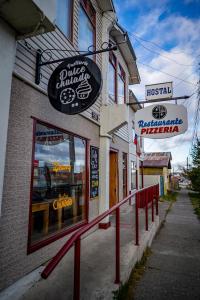 a building with signs on the side of a street at Hostal Alcázar in Puerto Natales