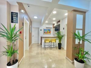 a hallway of a hospital with two plants at Comfort Apartments Pasha in Budva