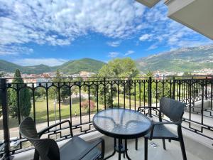 a balcony with a table and chairs and a view at Comfort Apartments Pasha in Budva
