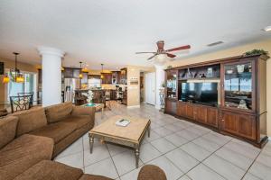 a living room with a couch and a tv at Florida Villa in Palm Harbor