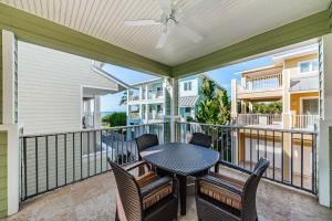 a patio with a table and chairs on a balcony at Exclusive Isla Bonita in Clearwater Beach