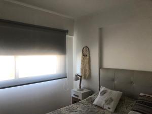 a bedroom with a bed and a window at La Plata Bs As , departamento vista panoramica a metros de todo in La Plata