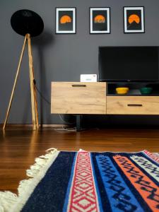 a living room with a television and a rug at Alen Apartment Old town - Free Parking in Sarajevo