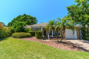 a house with a palm tree in a yard at Coconut Beach House in Clearwater Beach