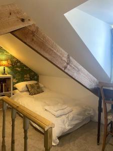 a bed in a room with an attic at Charming artist’s cottage in East Knoyle