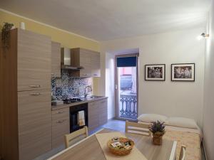 a kitchen and living room with a table and a room at Villa Ecclesiae in Iglesias