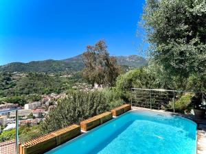 a swimming pool with a view of the mountains at Détente Côte d'azur, piscine et spa privatifs in Menton