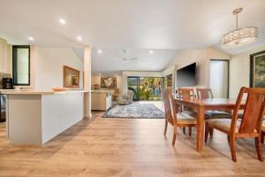 a kitchen and dining room with a table and chairs at WAILEA ELUA, #1104 condo in Wailea