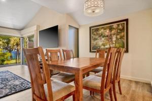 a dining room with a wooden table and chairs at WAILEA ELUA, #1104 condo in Wailea +34 photos