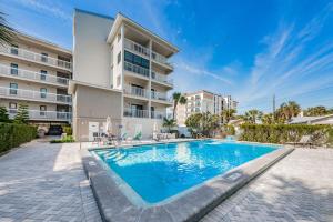 a swimming pool in front of a building at Villas of Clearwater Beach - Unit A17 in Clearwater Beach