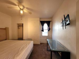 a bedroom with a bed and a window and a glass table at Downtown Norfolk private room D1 in Norfolk