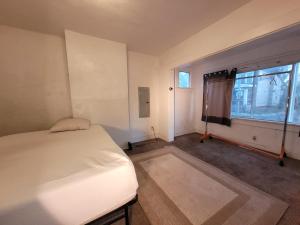 an empty room with a bed and a window at Downtown Norfolk private room D1 in Norfolk
