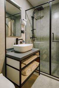 a bathroom with a sink and a shower at Bel Mare Boutique Hotel in Batumi