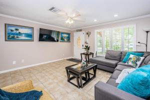 a living room with a couch and a table at Sweet Escape Cottage in Clearwater Beach