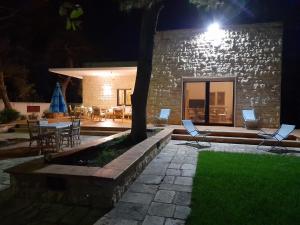 a patio at night with chairs and a table at Villa Rossi in Polignano a Mare