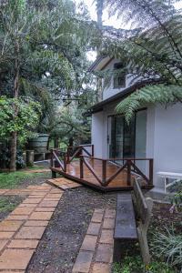 a house with a bench in front of it at Pousada Villa Verde in Canela