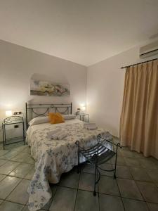 a bedroom with a bed and a window at Da Carmelo, Apartments & Rooms in Palinuro