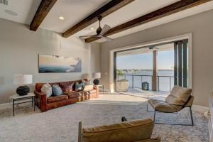 a living room with a couch and chairs and a large window at Bayside Paradise Mansion in Clearwater Beach