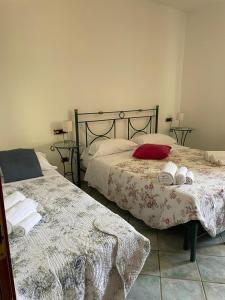 a bedroom with two beds with towels on them at Da Carmelo, Apartments & Rooms in Palinuro
