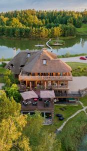 an aerial view of a large building on a lake at Jonathan Spa Estate in Amatciems