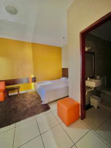 a bedroom with a bed and a table and a mirror at Hotel Centro Villarrica in Villarrica