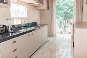 a kitchen with a sink and a counter top at Urban center apartamentos in Salto del Guairá