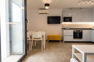 a kitchen and dining room with a table and chairs at E1 Rock View Studio9 -Hosted by Sweetstay in Gibraltar