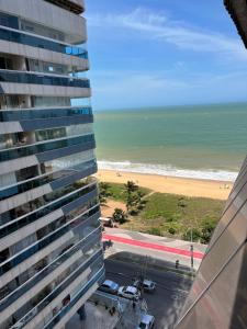 a view of the beach from the balcony of a building at Loft com vista da praia da Costa 612 in Vila Velha