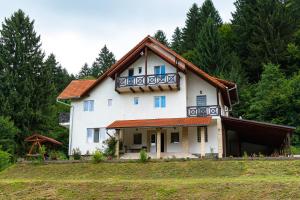 a large white house with a red roof at Casa Negru Vodă Breaza in Breaza