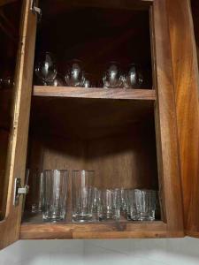 a cabinet filled with empty glasses on a shelf at Villa Gordon in Santa Cruz de Barahona