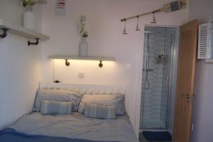 a bedroom with a bed with pillows and a door at The Whitstable, Tankerton Bolt Hole - Double Room & Ensuite in Kent