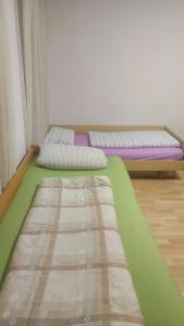 a room with two beds in a room at Restoran Ruža in Jablanica