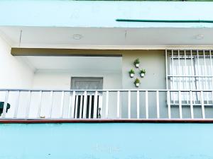 a balcony of a house with flowers on it at Aparta Hotel Downtown Guatapé in Guatapé