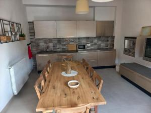a kitchen with a wooden table and chairs in it at El Molí de Fornells in Fornells de la Selva
