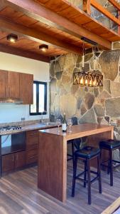 a kitchen with a large wooden island with stools at 7 Valles in Ensenada
