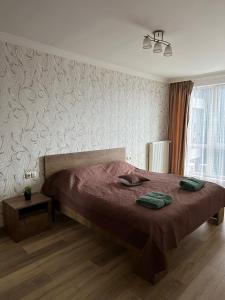 a bedroom with a large bed with a red blanket at Chornovola Apartment Липинського 28 in Lviv