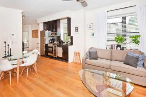 a living room with a couch and a table at Three Bedroom West Village Townhouse in New York