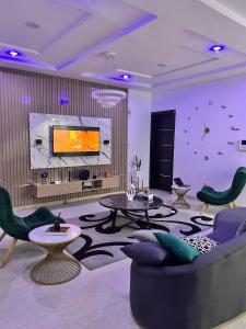 a living room with a couch and a tv at Luxury Shortlet Apartment LBS, AJAH in Lagos