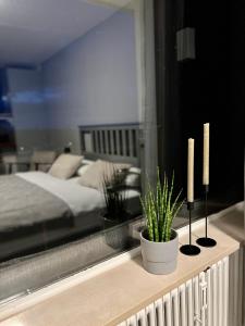 a bedroom with a bed and two candles on a ledge at KELLER APARTMENT I 106 Kniebis in Freudenstadt