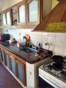 a kitchen counter with a sink and a stove at Casa al pie de la montaña in San Roque