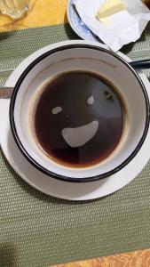 a plate with a cup of coffee on a table at Prince des carrés in Saint-Malo-en-Douziois