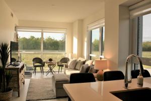 a living room with a couch and a table at 2 bedroom 2 bath Aquarius, Friday Harbour, Innisfil, Barrie in Innisfil