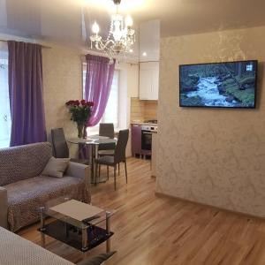 a living room with a couch and a table at Energia 2 Apartment in the city center in Narva