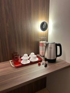 a counter with a coffee pot and cups on it at ALBARI HOUSE in Bologna +24 photos