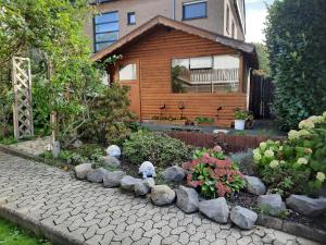 a garden with rocks in front of a house at Im Vulkanparkherz in Glees